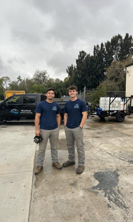 Exterior cleaning crew in front of their service truck